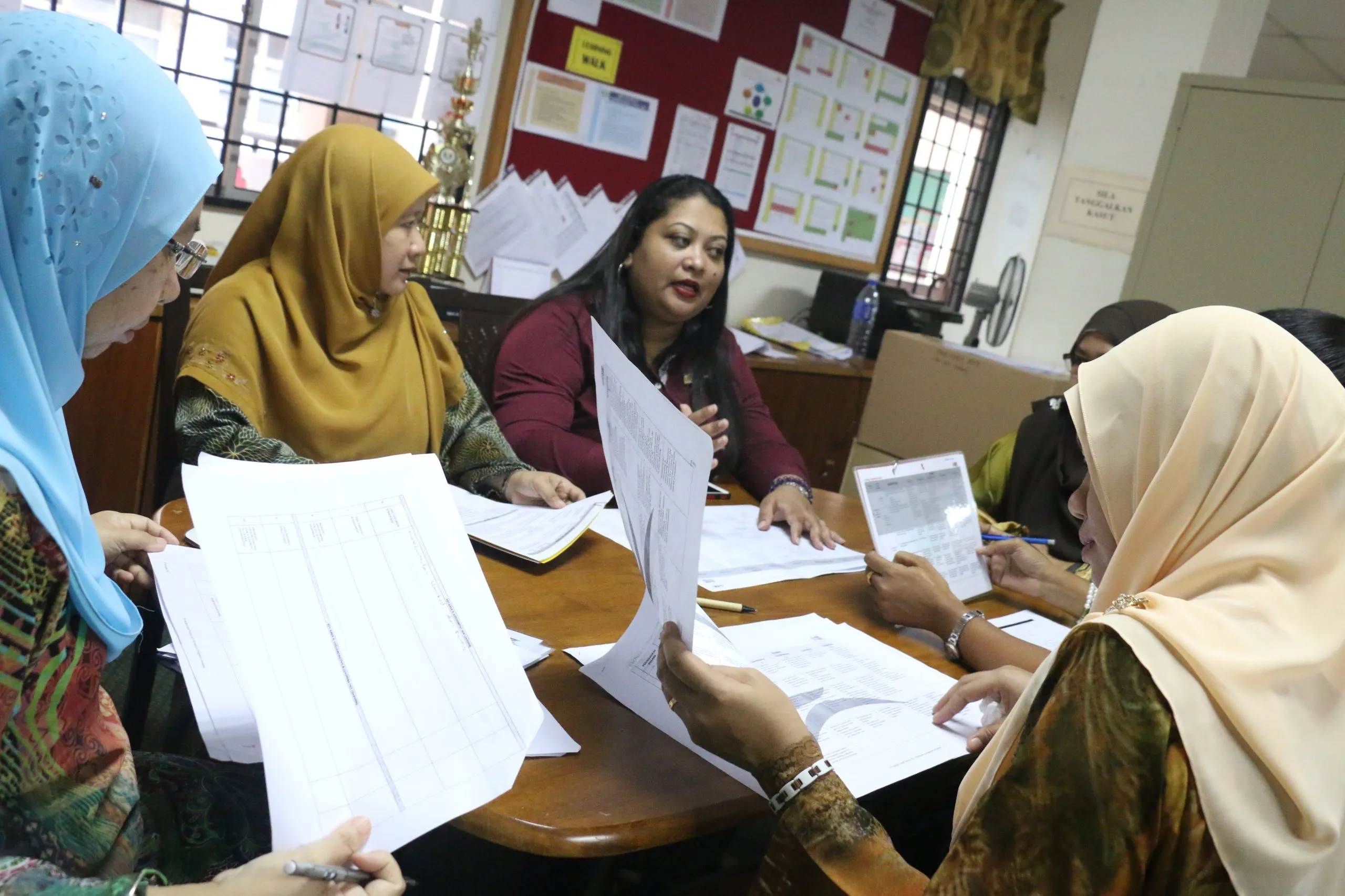 Teachers discussing papers during a training session